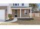 Front entrance with brick columns, a black door and a small walkway at 2700 Sunrose Ln, Johns Island, SC 29455