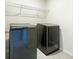 Laundry room with modern washer and dryer and overhead shelving at 2700 Sunrose Ln, Johns Island, SC 29455