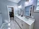 Double vanity bathroom with marble countertop and walk-in closet access at 273 Plantation Ln, Walterboro, SC 29488