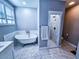 Elegant bathroom with soaking tub, walk-in shower, and marble tile floors at 273 Plantation Ln, Walterboro, SC 29488