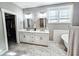 Double vanity bathroom with white cabinets and marble flooring at 273 Plantation Ln, Walterboro, SC 29488