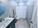 Clean bathroom with marble floors and a white shower curtain at 273 Plantation Ln, Walterboro, SC 29488