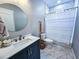 Clean bathroom with marble floors and a white shower curtain at 273 Plantation Ln, Walterboro, SC 29488