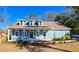 Charming light blue house with a front porch and landscaped yard at 273 Plantation Ln, Walterboro, SC 29488