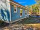 Side view of a light blue house showcasing its siding and windows at 273 Plantation Ln, Walterboro, SC 29488