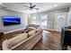 Spacious living room with hardwood floors, sofas, and a large TV at 273 Plantation Ln, Walterboro, SC 29488