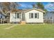 Newly renovated home with a white exterior, gray accents, and a landscaped lawn at 2943 Alabama Dr, North Charleston, SC 29405