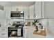 Stylish kitchen featuring white cabinets, stainless steel appliances, and quartz countertops at 2943 Alabama Dr, North Charleston, SC 29405