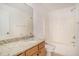 Clean bathroom with granite countertop, wood cabinets, and a bathtub at 2978 Sugarberry Ln, Johns Island, SC 29455