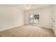 Bright bedroom featuring carpet, sliding glass door to balcony, and lake view at 2978 Sugarberry Ln, Johns Island, SC 29455