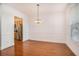 Dining room with hardwood floors, chandelier, and kitchen view at 2978 Sugarberry Ln, Johns Island, SC 29455