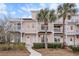 Three-story peach building with white trim, balconies, and palm trees at 2978 Sugarberry Ln, Johns Island, SC 29455