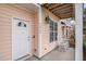 Front entrance with white door, rocking chairs, and covered porch at 2978 Sugarberry Ln, Johns Island, SC 29455