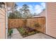 Small side yard with wooden fence and garden at 2978 Sugarberry Ln, Johns Island, SC 29455