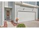 Attached two-car garage with white door and landscaping at 3012 Emma Ln, Mount Pleasant, SC 29466