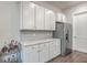 White kitchen cabinets, quartz countertops and stainless steel refrigerator at 3012 Emma Ln, Mount Pleasant, SC 29466