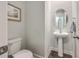 Elegant powder room with pedestal sink and oval mirror at 3012 Emma Ln, Mount Pleasant, SC 29466
