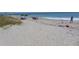 Sandy beach with people relaxing and enjoying the ocean at 345 Sea Cloud Cir # 345, Edisto Island, SC 29438