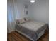 Cozy bedroom with patterned bedding, wood floors, and large window with curtains at 345 Sea Cloud Cir # 345, Edisto Island, SC 29438