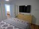 Spacious bedroom with en-suite bathroom access, dresser and TV at 345 Sea Cloud Cir # 345, Edisto Island, SC 29438