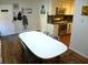 Bright dining area with white table and chairs, hardwood floors, and kitchen view at 345 Sea Cloud Cir # 345, Edisto Island, SC 29438