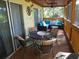 Screened porch with seating area and dining table at 345 Sea Cloud Cir # 345, Edisto Island, SC 29438
