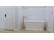 Freestanding bathtub with gold fixtures and marble tile at 420 Greenwich St, Mount Pleasant, SC 29464