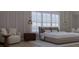 Serene bedroom featuring a king-size bed, wood nightstand and comfortable armchair at 420 Greenwich St, Mount Pleasant, SC 29464