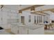 Modern white kitchen with gold accents and large island at 420 Greenwich St, Mount Pleasant, SC 29464