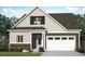 Two-story house with a beige exterior, brown accents, and a two-car garage at 427 Evening Glow Ln, Summerville, SC 29486