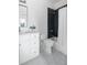 Modern bathroom with white vanity, herringbone floor, and dark tile shower at 507 Mccants Dr, Mount Pleasant, SC 29464