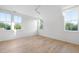 Bright bedroom featuring hardwood floors and large windows with treetop views at 507 Mccants Dr, Mount Pleasant, SC 29464