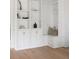 White built-in shelving with seating area and storage at 507 Mccants Dr, Mount Pleasant, SC 29464
