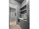 Gray butler's pantry with quartz countertops and shelving at 507 Mccants Dr, Mount Pleasant, SC 29464