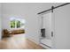 Elegant hallway with hardwood floors, barn door, and built-in seating at 507 Mccants Dr, Mount Pleasant, SC 29464