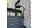Black rain shower head on brick wall near fence at 507 Mccants Dr, Mount Pleasant, SC 29464