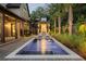 Tranquil pool scene at night with warm lighting at 507 Mccants Dr, Mount Pleasant, SC 29464