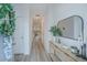 Bright and airy entryway with light wood console table, mirror, and fresh greenery at 553 Trotters Ln, Moncks Corner, SC 29461