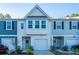 Two-story townhome with gray and white siding, two-car garage, and landscaping at 553 Trotters Ln, Moncks Corner, SC 29461