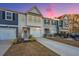 Two-story townhome with gray and white siding, two-car garage, and landscaping at 553 Trotters Ln, Moncks Corner, SC 29461