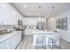 Modern kitchen with white cabinets, stainless steel appliances, and quartz countertops at 553 Trotters Ln, Moncks Corner, SC 29461