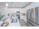 Modern kitchen with white cabinets, stainless steel appliances, and quartz countertops at 553 Trotters Ln, Moncks Corner, SC 29461