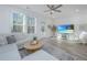 Relaxing living room with sectional sofa, large TV, and hardwood floors at 553 Trotters Ln, Moncks Corner, SC 29461