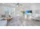 Spacious living room with large TV, sectional sofa, and wood-look floors at 553 Trotters Ln, Moncks Corner, SC 29461