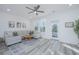 Light-filled living room featuring a comfy sectional sofa and wood-look floors at 553 Trotters Ln, Moncks Corner, SC 29461
