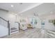 Bright living room with L-shaped sofa, ceiling fan, and access to backyard at 553 Trotters Ln, Moncks Corner, SC 29461