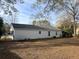 Large backyard with leaf covered lawn and partial view of a neighboring home at 7640 Hillview Ln, North Charleston, SC 29420