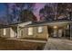 Newly renovated brick ranch home with carport at dusk at 7640 Hillview Ln, North Charleston, SC 29420