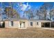 Brick ranch house with carport, landscaping, and a green door at 7640 Hillview Ln, North Charleston, SC 29420
