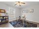 Home office with built in shelving, hardwood floors, and a glass desk at 7640 Hillview Ln, North Charleston, SC 29420